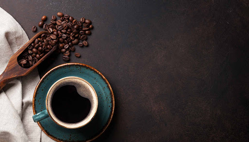 A single cup of carefully brewed coffee resting in a warm, dimly lit space